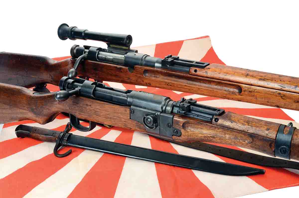 Included here is a (front) IJA Paratrooper version of a Type 99 7.7mm and a (rear) Type 97 6.5mm sniper rifle with 2.5x scope. The bayonet is a Type 30.